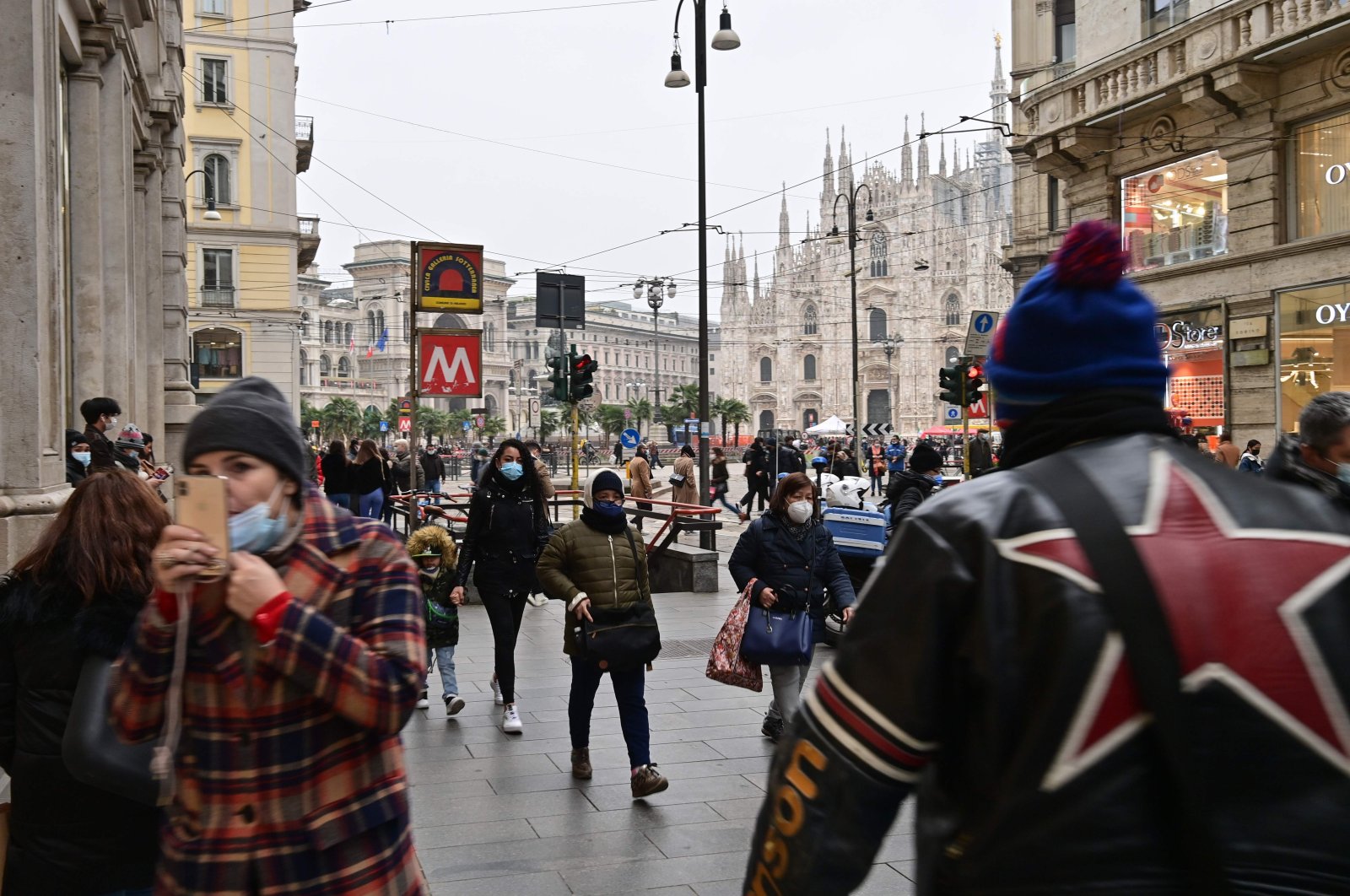 People stroll by Duomo square in downtown Milan after the Italian government eased anti-COVID-19 restrictions in the Lombardy region, Italy, Feb. 6, 2021. (AFP Photo)