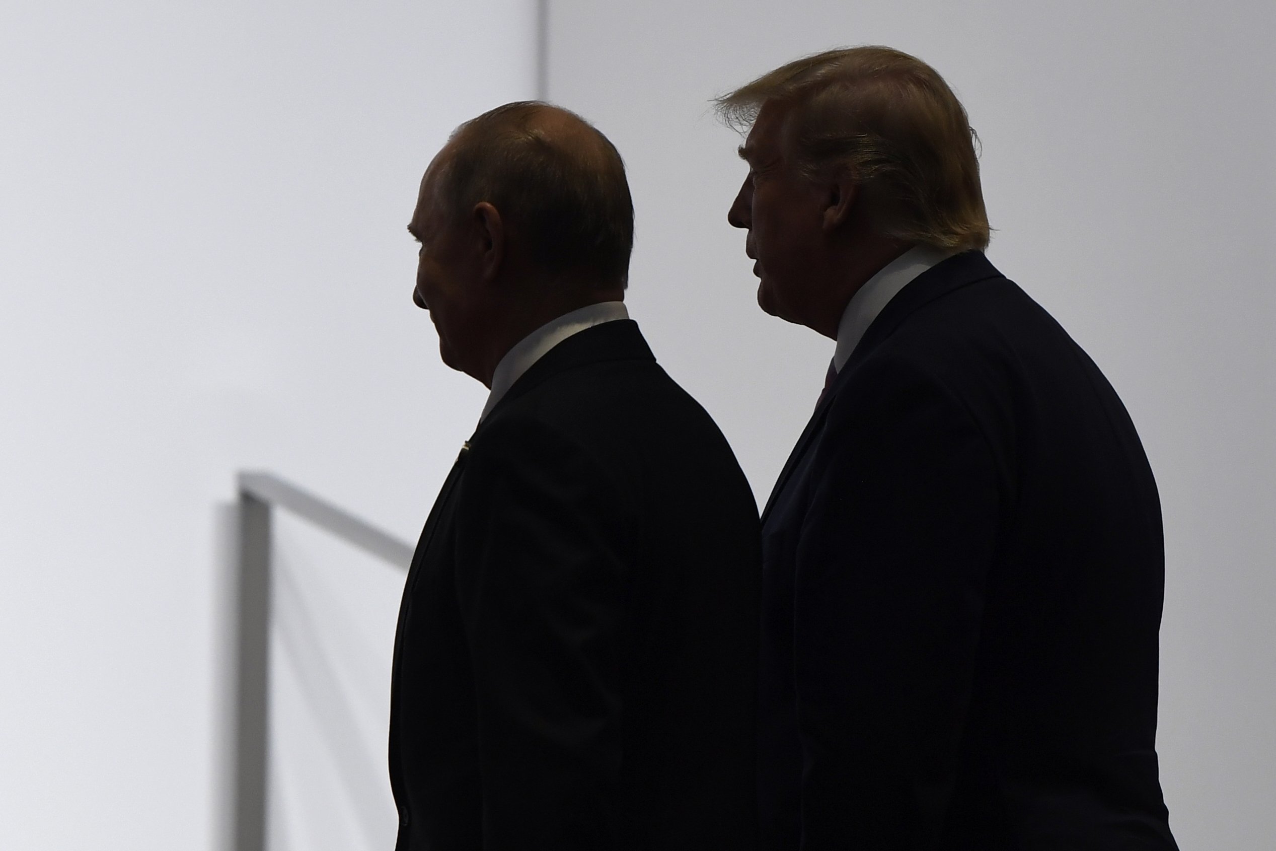 U.S. President Donald Trump and Russian President Vladimir Putin walk to participate in a group photo at the G-20 summit in Osaka, Japan, June 28, 2019. (AP Photo)