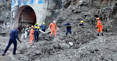 This photograph provided by National Disaster Response Force shows personnel preparing to rescue workers at one of the hydropower projects at Reni village in Chamoli district of the Indian state of Uttarakhand, Monday, Feb. 8, 2021.(National Disaster Response Force via AP)