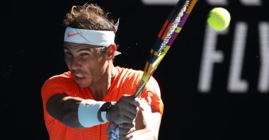 Spain's Rafael Nadal makes a backhand return to Serbia's Laslo Djere during their first-round match at the Australian Open, in Melbourne, Australia, Feb. 9, 2021. (AP Photo)