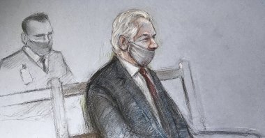 This is a court artist sketch by Elizabeth Cook of Julian Assange appearing at the Old Bailey in London for the ruling in his extradition case, in London, Monday, Jan. 4, 2021. (Elizabeth Cook / PA via AP)