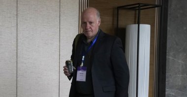 Peter Daszak of the World Health Organization team, walks to a conference center in the cordoned off wing of the hotel in Wuhan in central China's Hubei province on Monday, Feb. 8, 2021. (AP Photo)