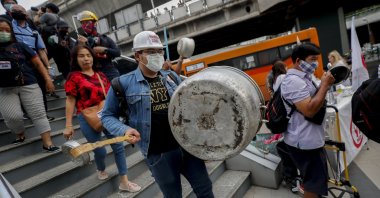 Pro-democracy protesters bang on pots and pans during a protest in Bangkok, Thailand, Feb. 10, 2021. (AP Photo)