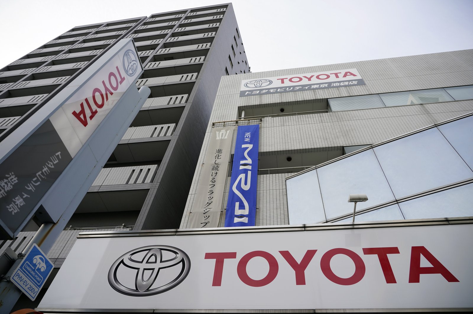 The Toyota Motor logo hangs outside the carmaker's retailer in Tokyo, Japan, Feb.10,  2021. (EPA Photo)
