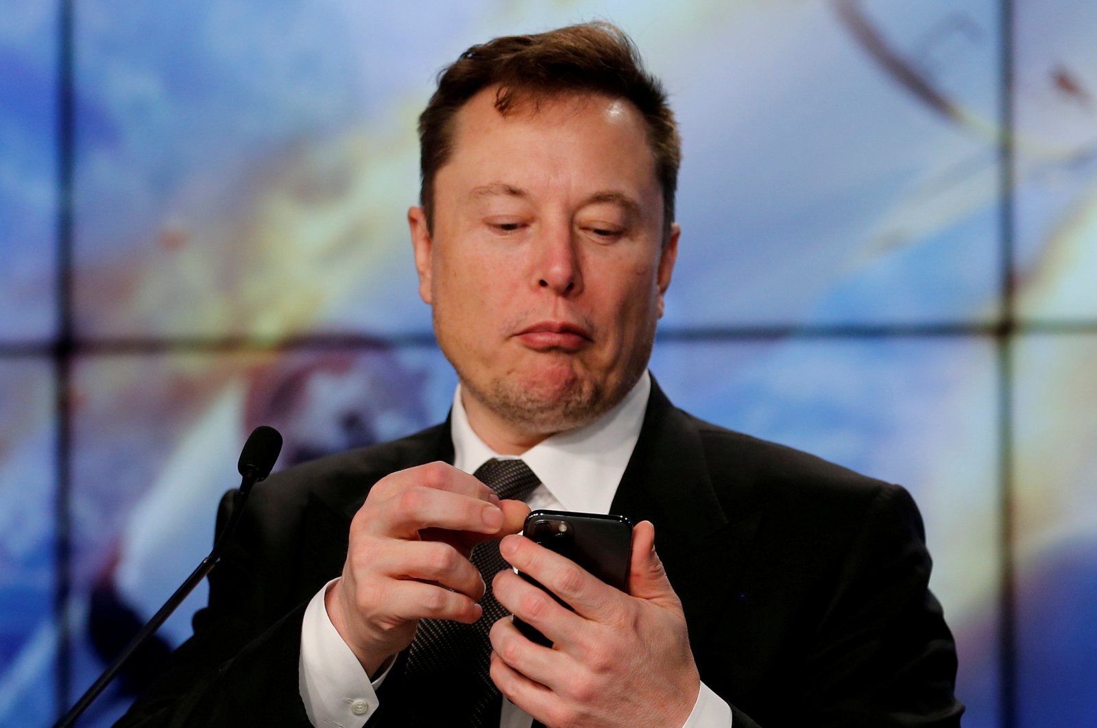 SpaceX founder and chief engineer Elon Musk looks at his mobile phone during a post-launch news conference to discuss the  SpaceX Crew Dragon astronaut capsule in-flight abort test at the Kennedy Space Center in Cape Canaveral, Florida, U.S. Jan. 19, 2020. (Reuters Photo)