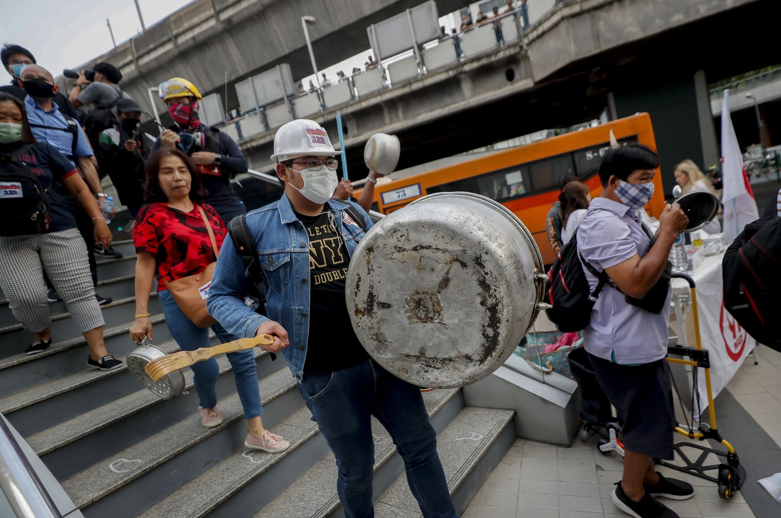Pro-democracy protesters bang on pots and pans during a protest in Bangkok, Thailand, Feb. 10, 2021. (AP Photo)