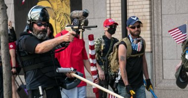 The Proud Boys face off against Black Lives Matter protesters using mace and a paintball gun, in downtown Portland, Oregon, U.S., Aug. 15, 2020. (Photo by Getty Images)