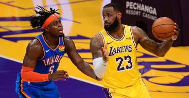 Los Angeles Lakers forward LeBron James (R) controls the ball against Oklahoma City Thunder forward Luguentz Dort during the overtime period at Staples Center, Los Angeles, California, U.S., Feb. 10, 2021. (Reuters Photo)