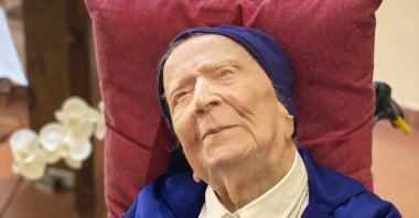 Sister Andre, born Lucile Randon, folds her hands at mass at the chapel of her care home in a photo provided by the Sainte-Catherine Laboure care home communications manager, Toulon, southern France, Feb. 11, 2021. (Sainte-Catherine Laboure care home / David Tavella via AP)