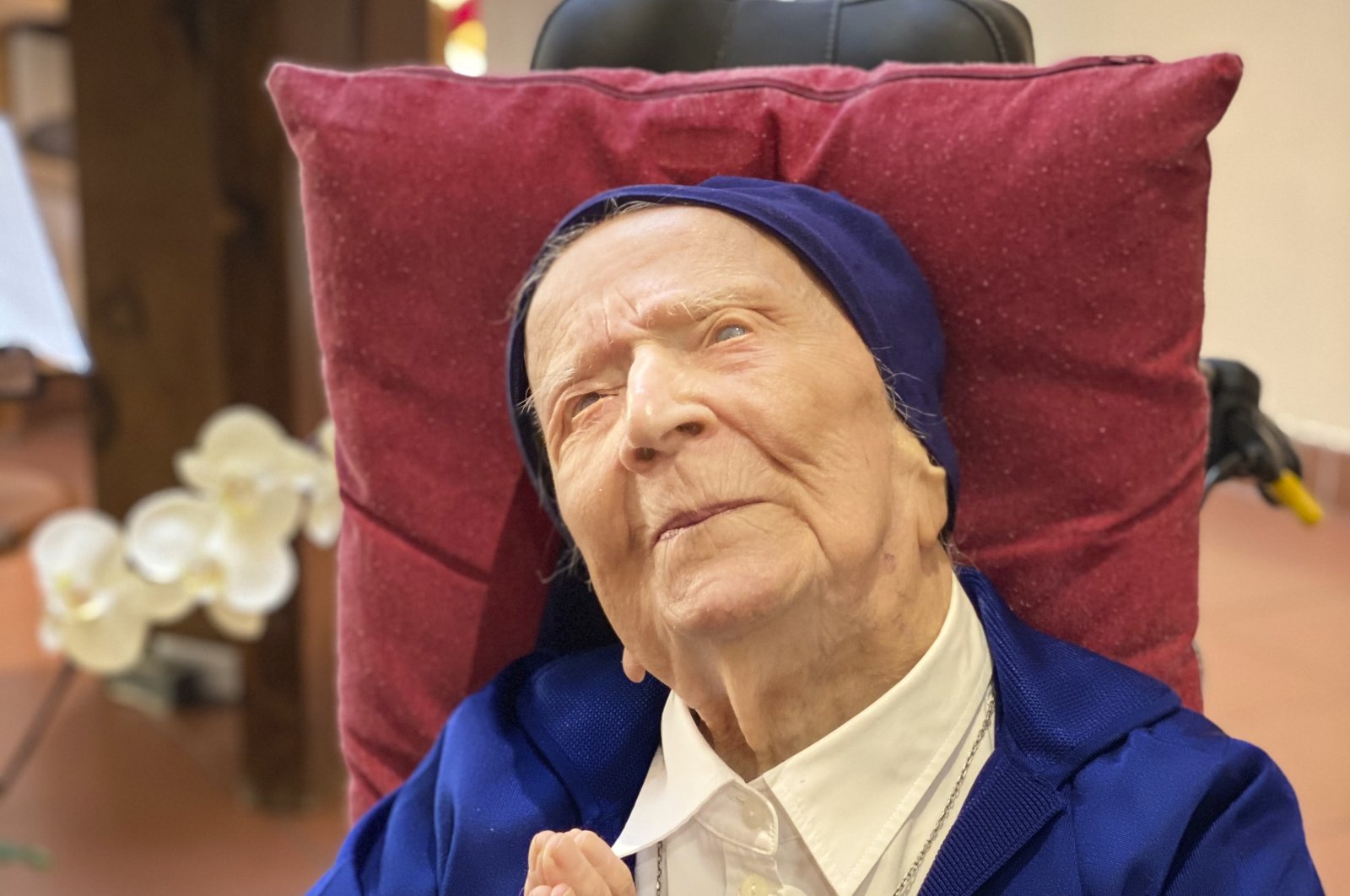 Sister Andre, born Lucile Randon, folds her hands at mass at the chapel of her care home in a photo provided by the Sainte-Catherine Laboure care home communications manager, Toulon, southern France, Feb. 11, 2021. (Sainte-Catherine Laboure care home / David Tavella via AP)