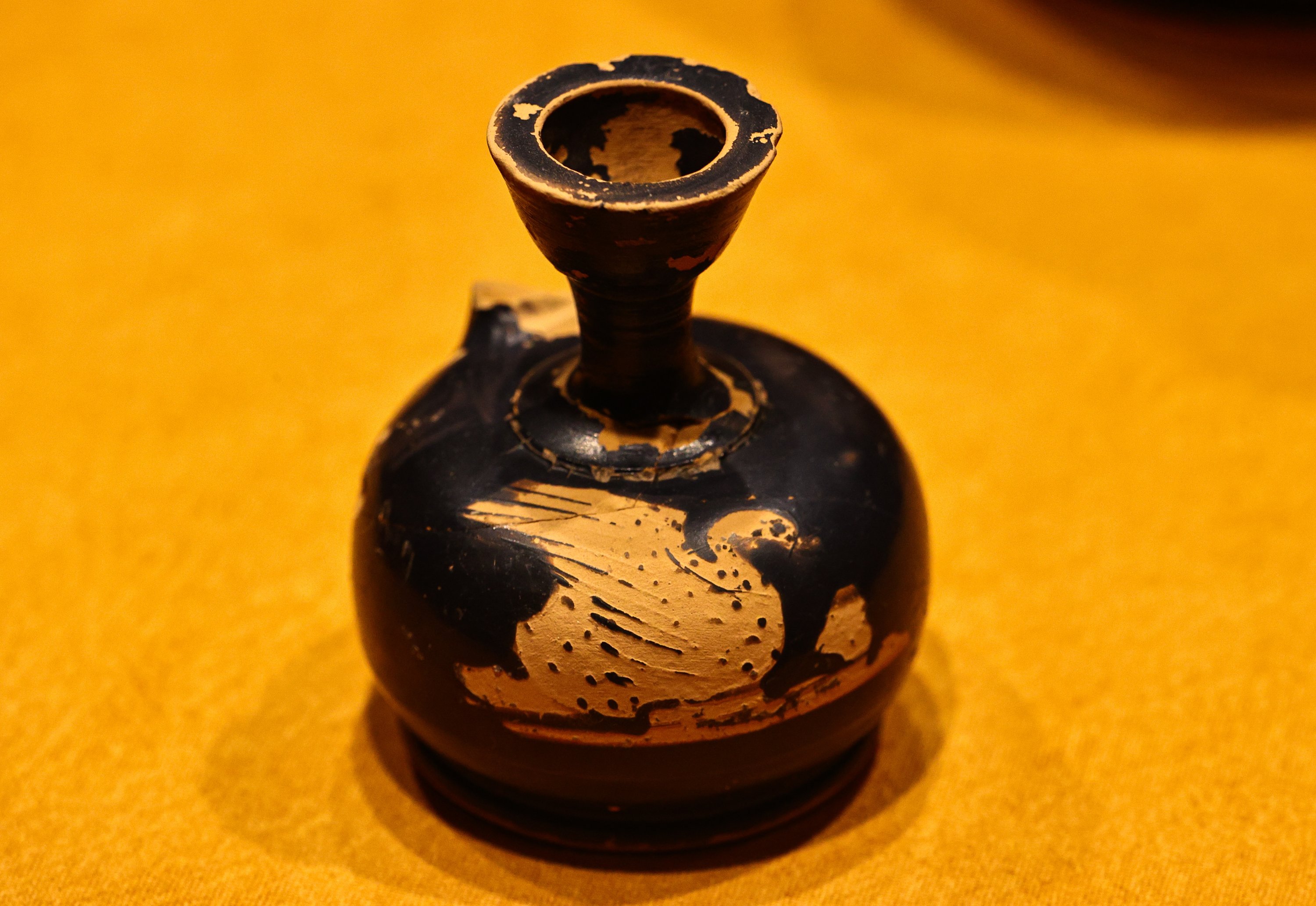 An ancient perfume bottle, decorated with an animal figure, can be seen on display at the Izmir Archaeological Museum, Izmir, western Turkey, Feb. 11, 2021. (AA Photo)
