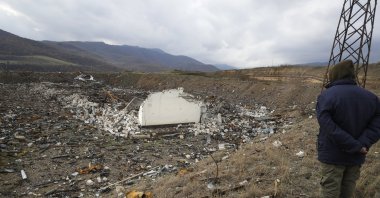 A member of a survey team from the Halo Trust mine-clearing organization looks on at a damaged ammunition store near the outskirts of the capital Stepanakert (Khankendi) of Nagorno-Karabakh, Azerbaijan, Nov. 23, 2020. (AP File Photo)