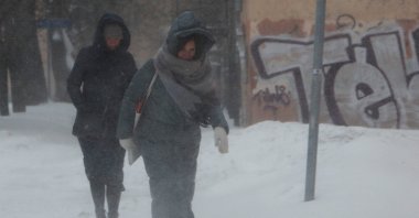 People walk along a street during heavy snowfall in Moscow, Russia on Feb. 12, 2021. (Reuters Photo)