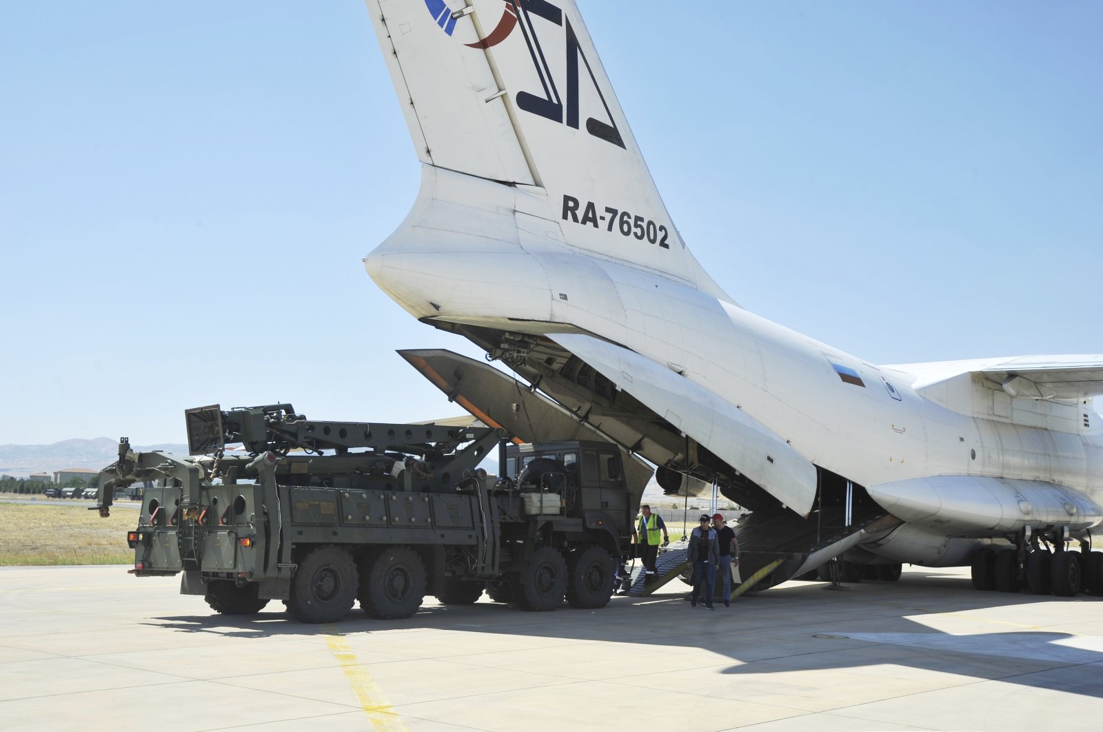 Military officials work around a Russian transport aircraft, carrying parts of the S-400 air defense systems, after it landed at Murted military airport outside Ankara, Turkey, Aug. 27, 2019. (Turkish Defense Ministry via AP, Pool)