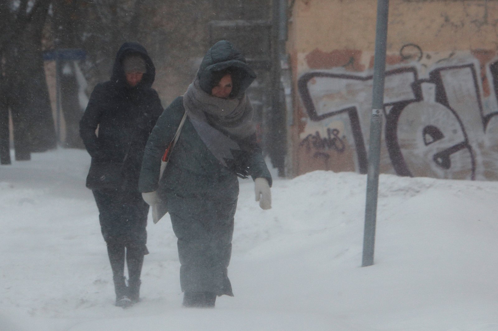 People walk along a street during heavy snowfall in Moscow, Russia on Feb. 12, 2021. (Reuters Photo)