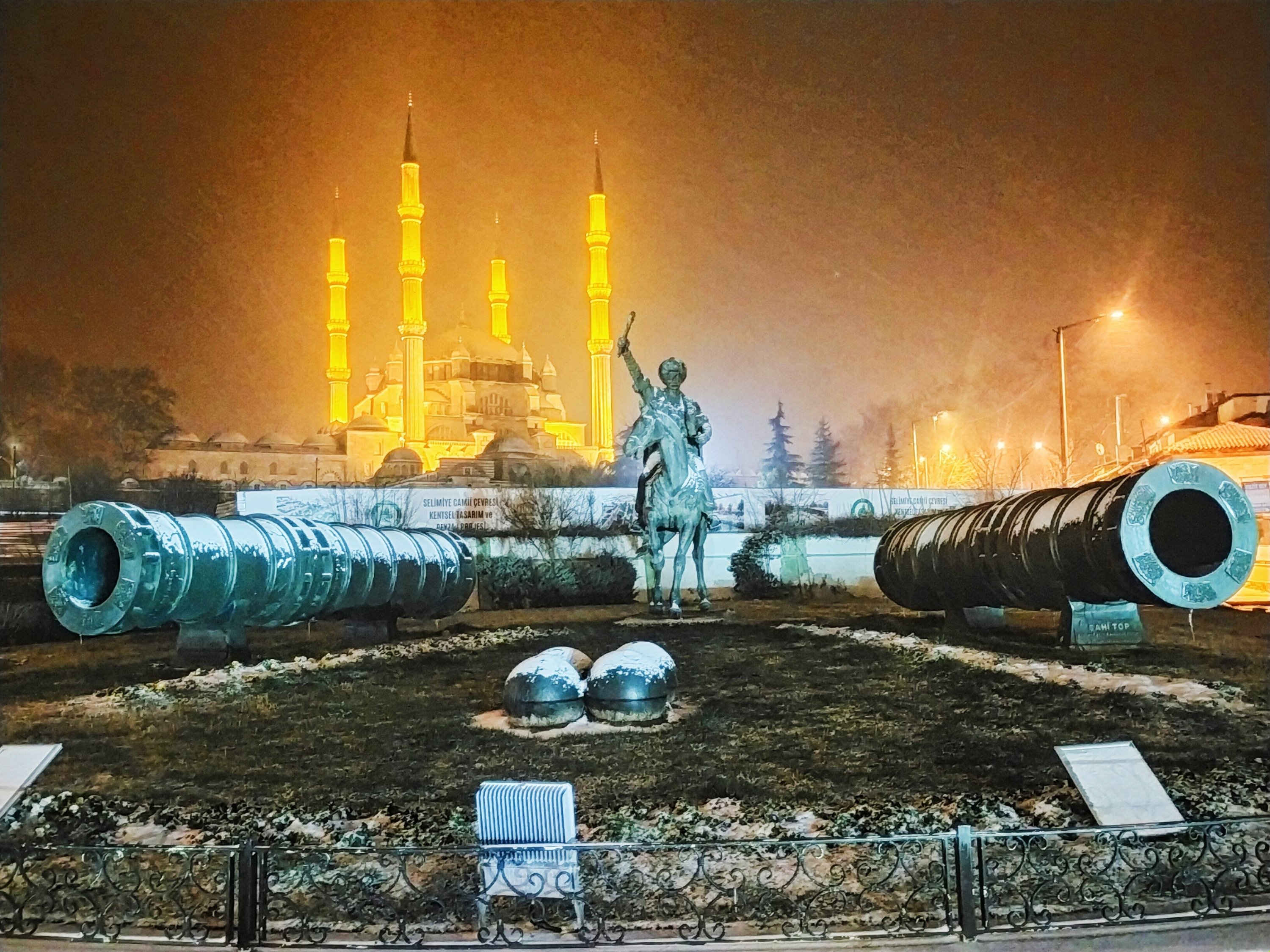 The historic Selimiye Mosque, and the landmark's famous Ottoman architect Sinan's statue, are seen during snowfall in Edirne, northwestern Turkey, Feb. 14, 2021. (IHA Photo)