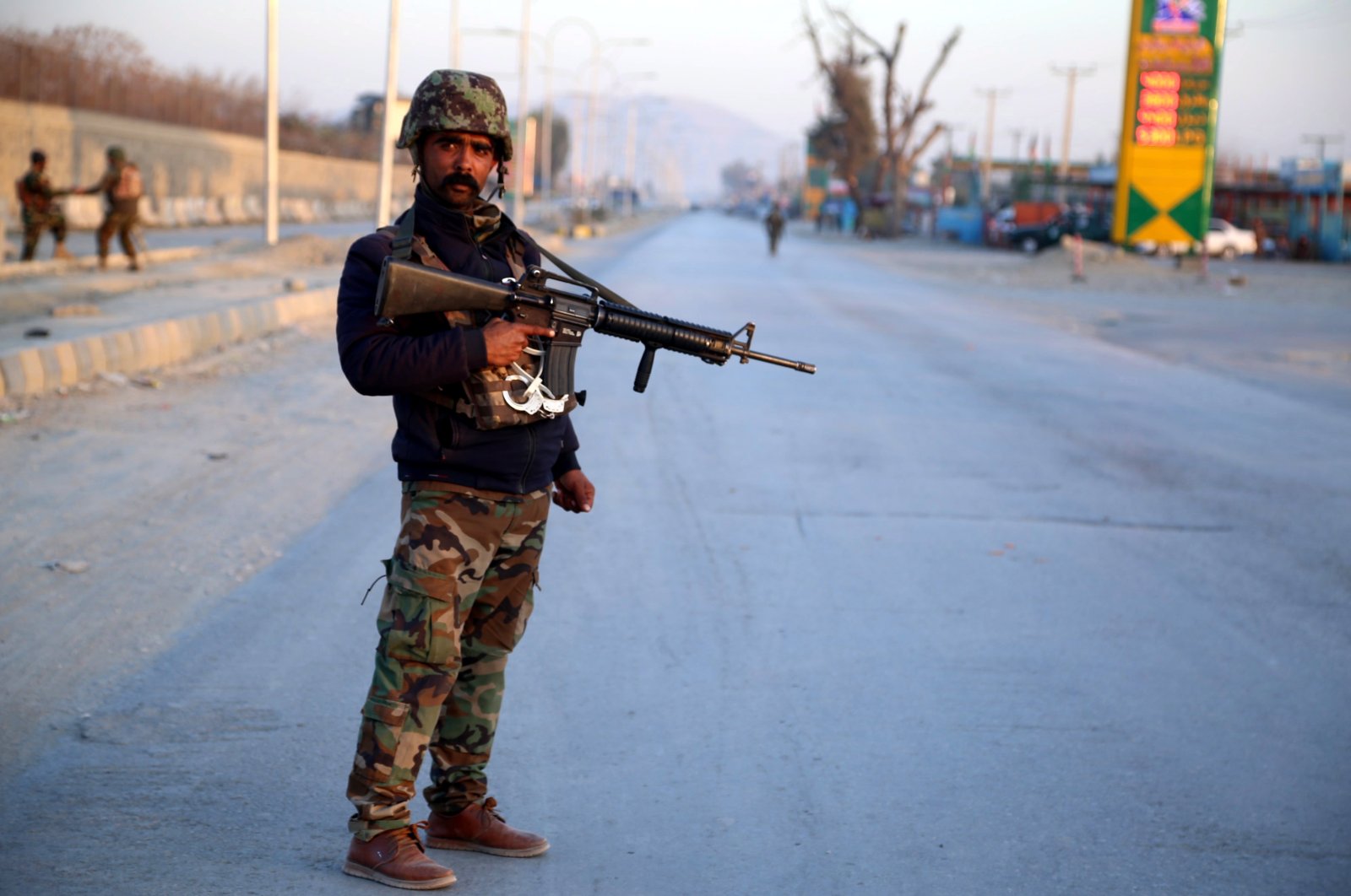 An Afghan soldier stands guard at the scene of a bomb blast that targeted the vehicle of security officials in Jalalabad, Afghanistan, Feb. 11, 2021. (EPA Photo)