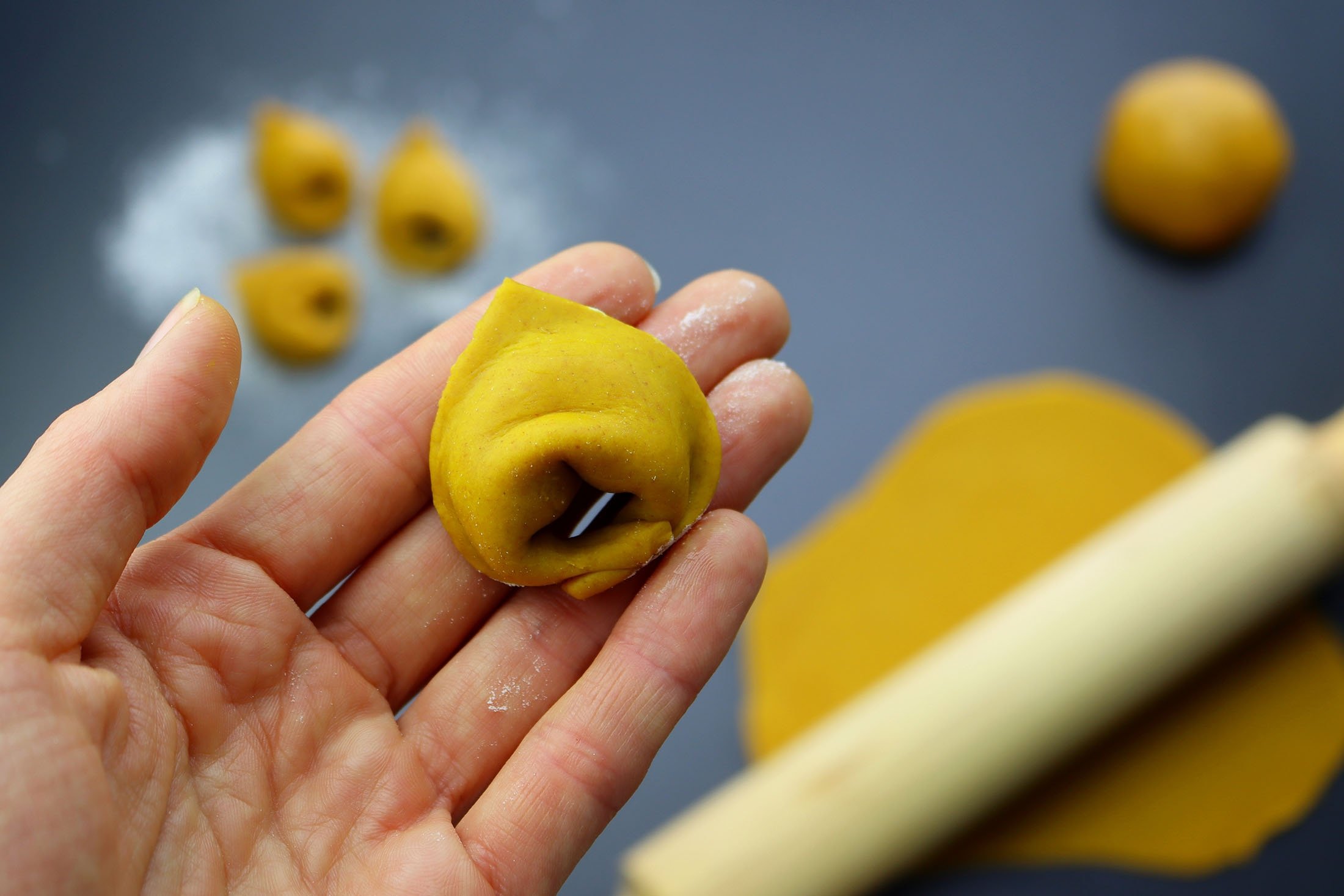 Once you fold the corners of your homemade tortellini, the shape should resemble something like this. (Shutterstock Photo)