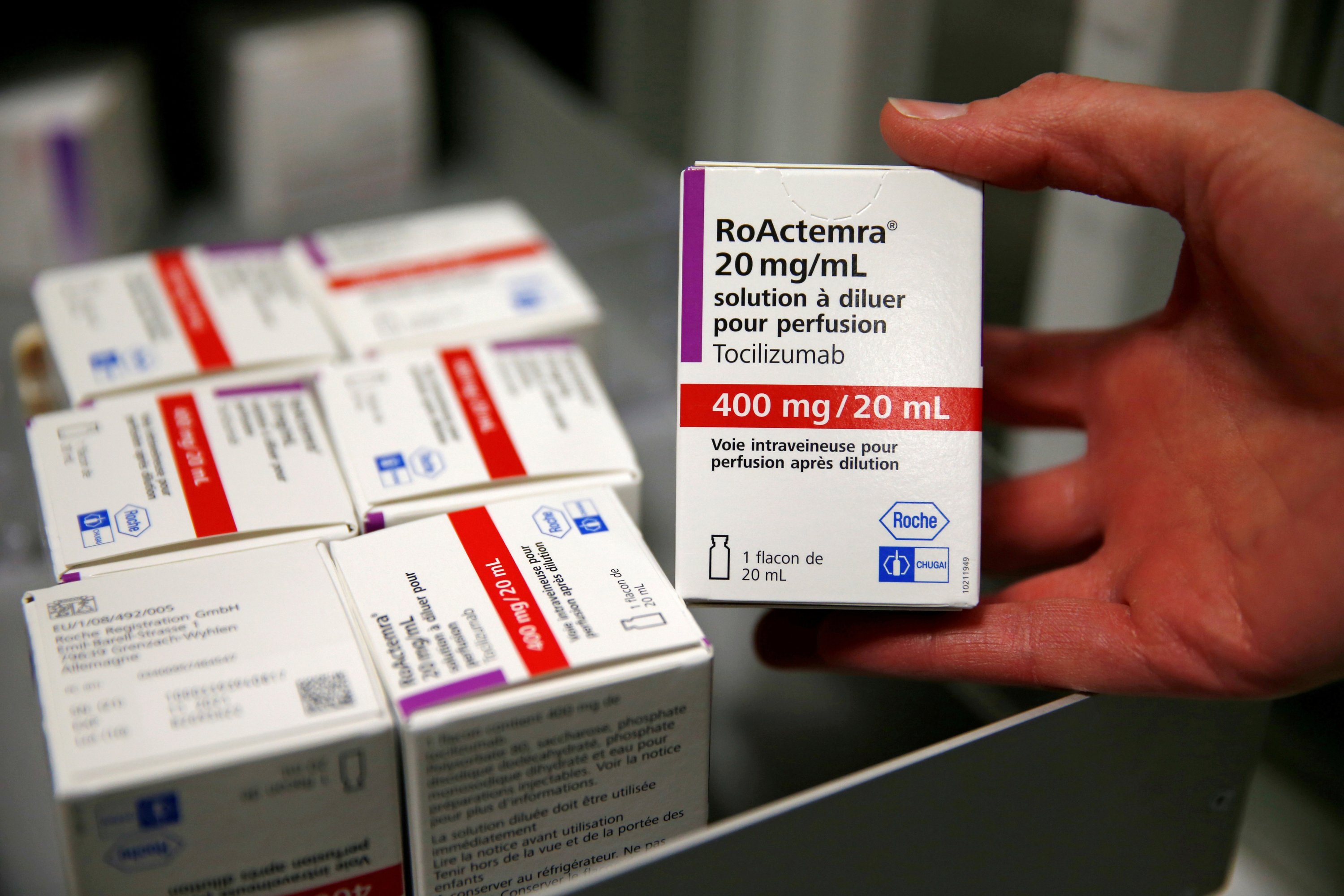 FILE PHOTO: A pharmacist displays a box of tocilizumab, which is used in the treatment of rheumatoid arthritis, at the pharmacy of Cambrai hospital, France, April 28, 2020. REUTERS/Pascal Rossignol/File Photo