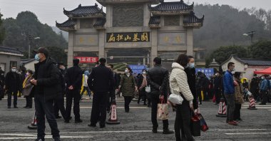People are seen outside the Biandanshan cemetery in Wuhan, in China's central Hubei province, Feb. 12, 2021. (AFP Photo)