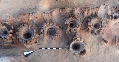 A handout picture released by the Egyptian Ministry of Tourism and Antiquities on Feb. 13, 2021, shows the remains of a row of vats used for beer fermentation, in a complex which may be the world's "oldest" high-production brewery, uncovered in the Abydos archaeological site near Egypt's southern city of Sohag. (Egyptian Ministry of Antiquities Photo / AFP)