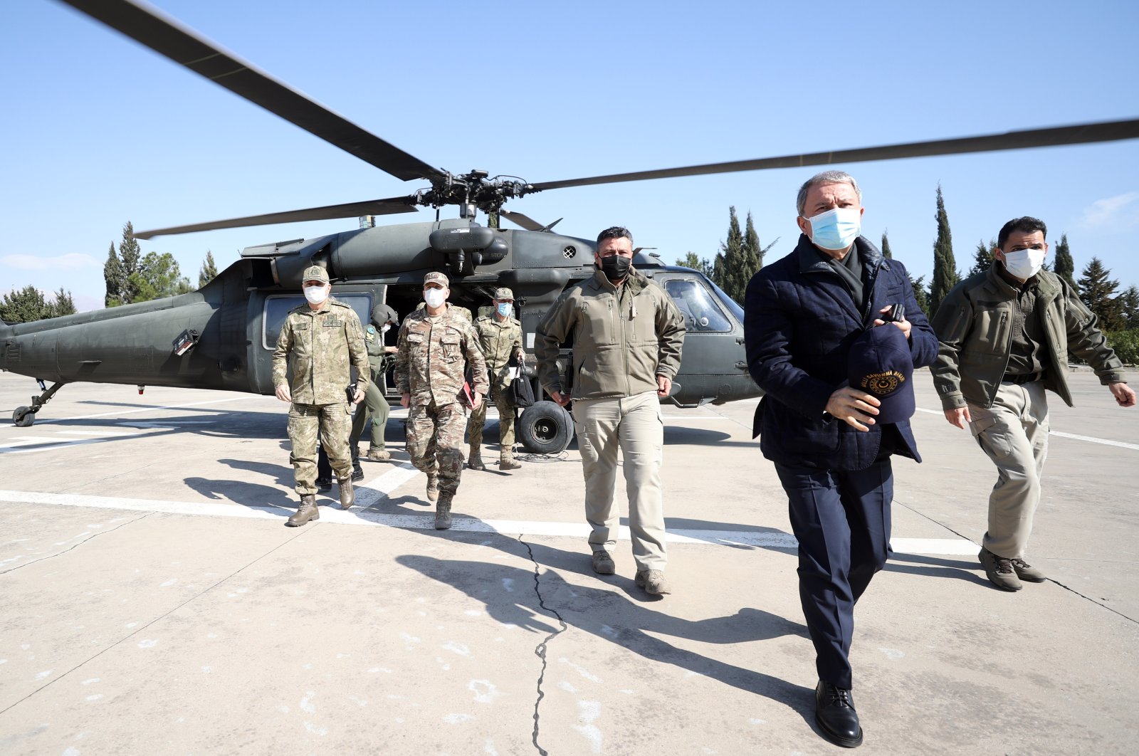 National Defense Minister Hulusi Akar and military officials get off a helicopter and walk toward the Iraqi border on Feb. 14, 2021. (AA Photo)