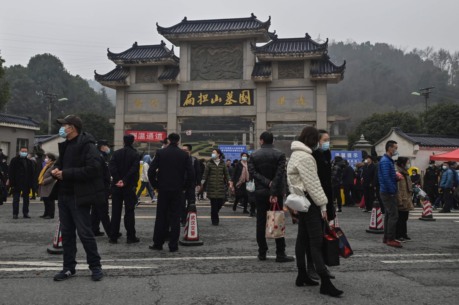 People are seen outside the Biandanshan cemetery in Wuhan, in China's central Hubei province, Feb. 12, 2021. (AFP Photo)