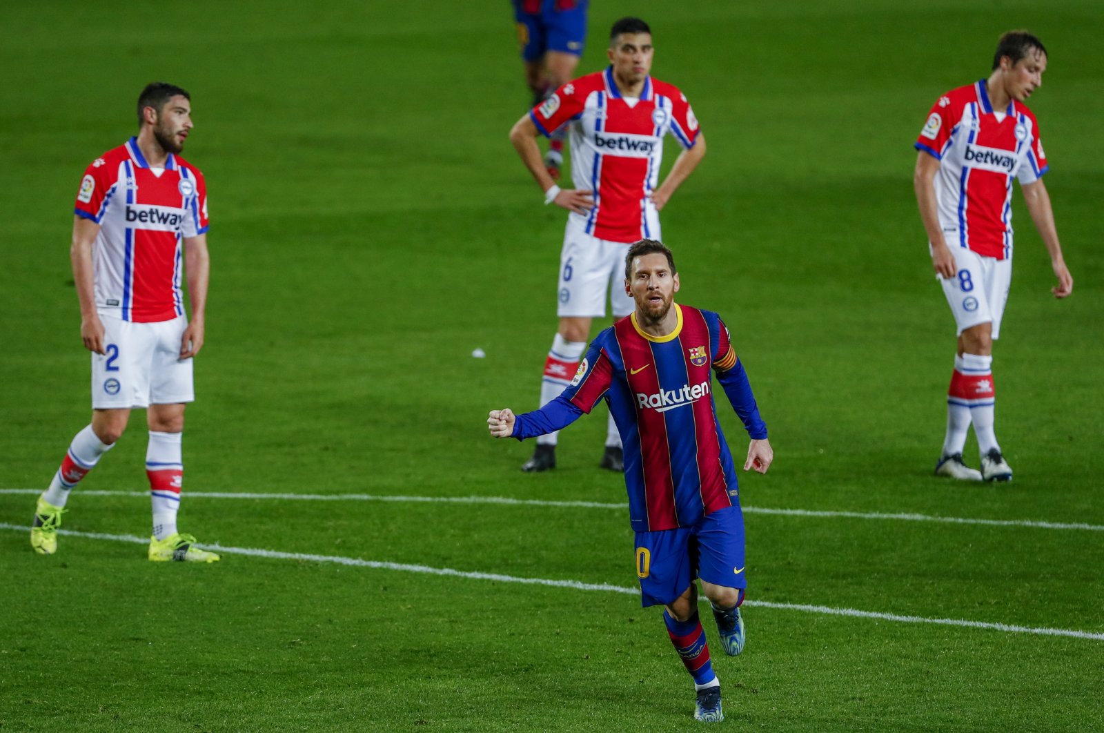 Barcelona's Lionel Messi celebrates scoring his side's second goal against Alaves at the Camp Nou, Barcelona, Spain, Feb. 13, 2021. (AP Photo)