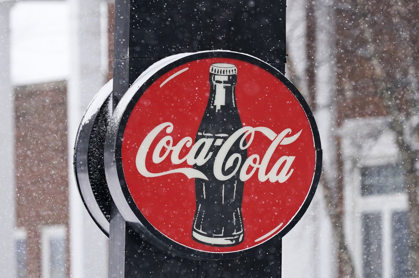 A Coca-Cola sign hangs outside a Coca-Cola distributor, in Bedford, Ohio, US, Feb. 9, 2021. (AP Photo)