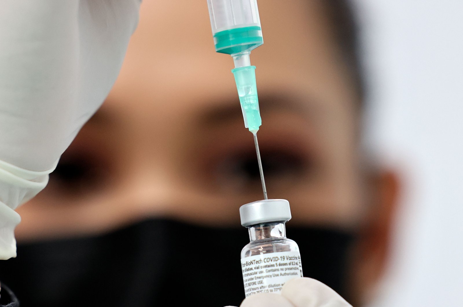 A health worker prepares an injection of the Pfizer-BioNTech vaccine against the coronavirus at a vaccination center, set up at the Dubai International Financial Center in the Gulf emirate of Dubai, on Feb. 3, 2021. (AFP Photo)