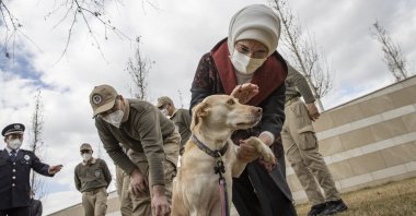 First lady Emine Erdoğan pets her adopted dog, named "Leblebi," meaning "roasted chickpea" in Turkish, as she delivers doghouses produced from the waste collected as part of the Zero Waste campaign during the construction of the Presidential Complex, in the garden of the Presidential Library, in the capital Ankara, Turkey, Feb. 10, 2021. (AA Photo)