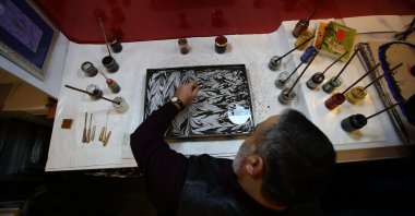 Mehmet Kotan prepares a marbling work with the powdered paint of the Oltu Stone in his workshop, Erzurum, eastern Turkey, Feb. 14, 2020. (AA PHOTO)