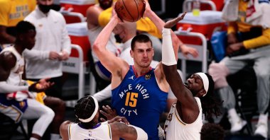 Denver Nuggets center Nikola Jokic (C) looks to pass the ball under pressure from Los Angeles Lakers guard Wesley Matthews (L) and center Montrezl Harrell (R) in the third quarter at Ball Arena, Denver, Colorado, Feb 14, 2021. (Reuters Photo)
