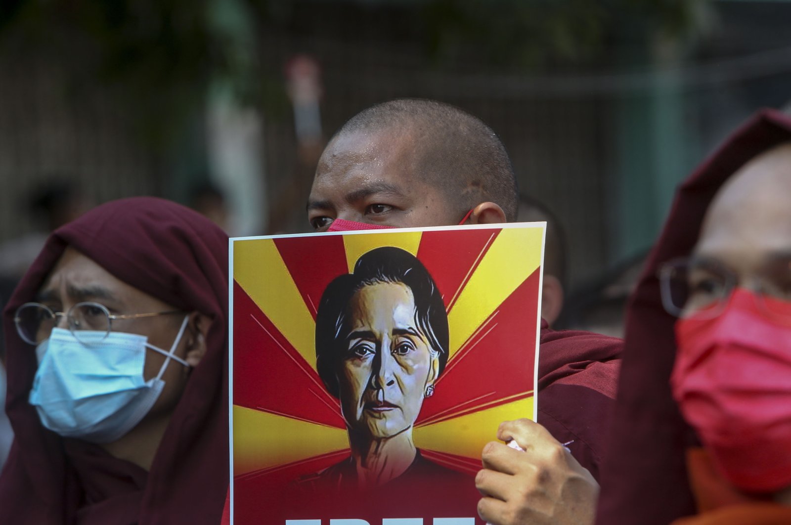 Buddhist monks display pictures of deposed leader Aung San Suu Kyi during a street march against the military coup in Mandalay, Myanmar, Feb. 12, 2021. (AP Photo)