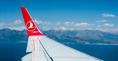 Mountains with snowy peaks seen from the window of the Turkish Airlines aircraft in this file photo from May 2019, Antalya, Turkey. (Shutterstock Photo by Tatiana Zolotareva )