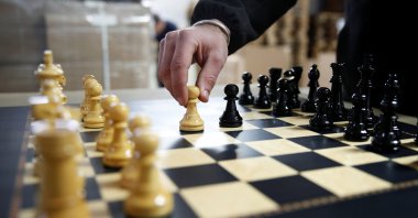 David Ferrer, Spanish chess board maker, moves a chess pawn on a chessboard at the Rechapados Ferrer factory in La Garriga, north of Barcelona, Spain, Feb. 11, 2021. (Reuters Photo)