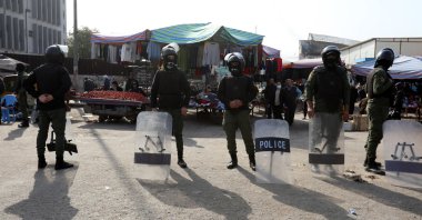 Police forces stand guard as Iraqis protest at the site of a suicide bomb attack that targeted a popular market on Jan. 21, Baghdad, Iraq, Jan. 25, 2021. (EPA File Photo)