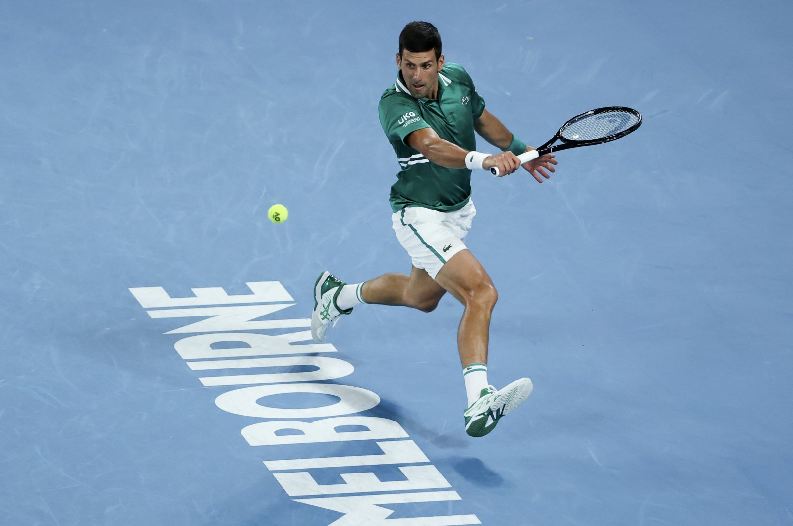 Serbia's Novak Djokovic hits a backhand return to Germany's Alexander Zverev during their quarterfinal match at the Australian Open tennis championship in Melbourne, Australia, Feb. 16, 2021. (AP Photo)