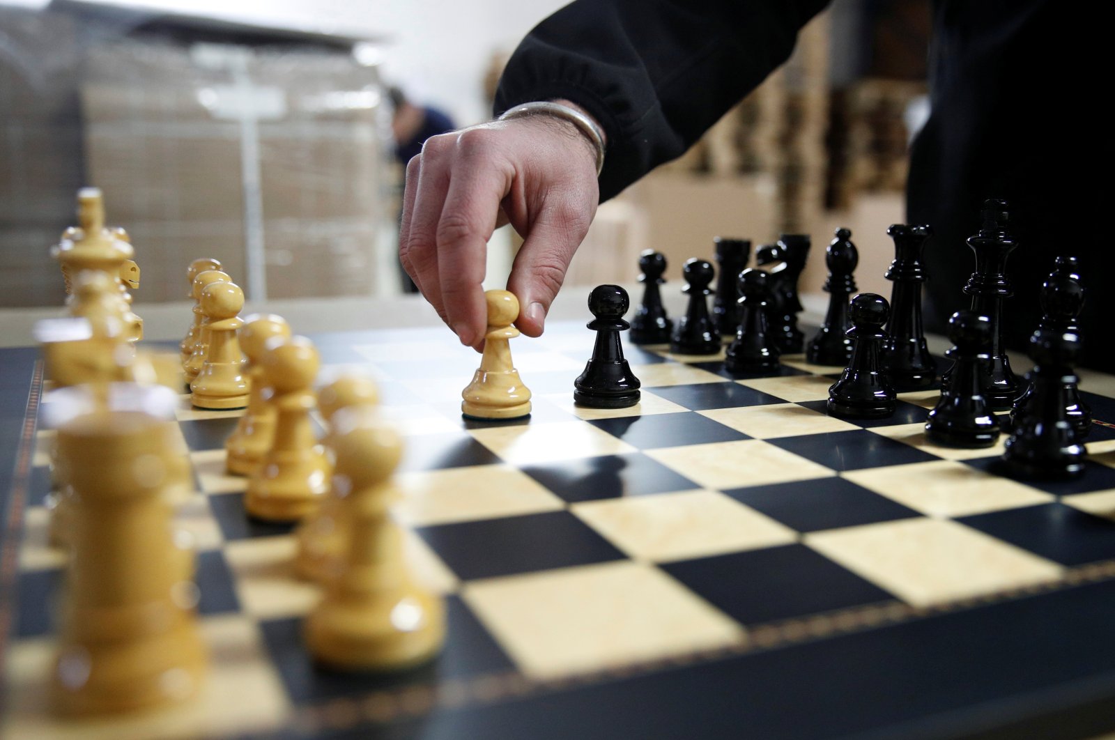 David Ferrer, Spanish chess board maker, moves a chess pawn on a chessboard at the Rechapados Ferrer factory in La Garriga, north of Barcelona, Spain, Feb. 11, 2021. (Reuters Photo)