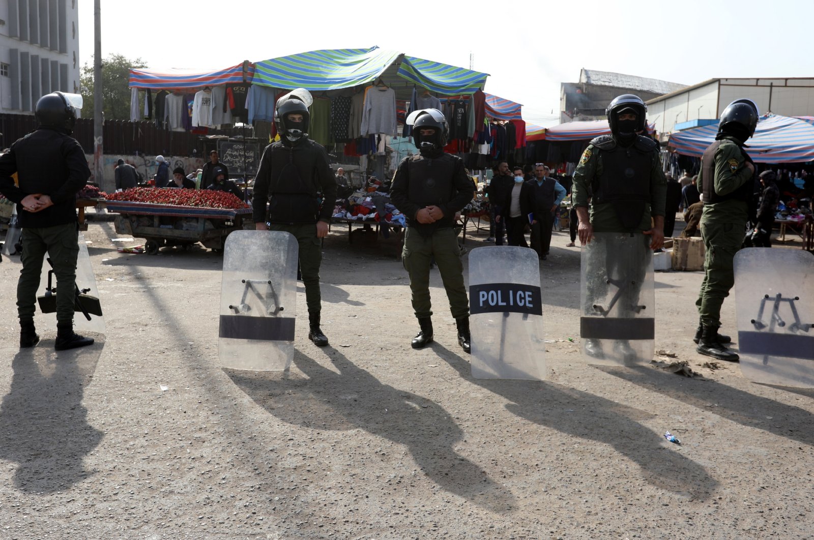 Police forces stand guard as Iraqis protest at the site of a suicide bomb attack that targeted a popular market on Jan. 21, Baghdad, Iraq, Jan. 25, 2021. (EPA File Photo)