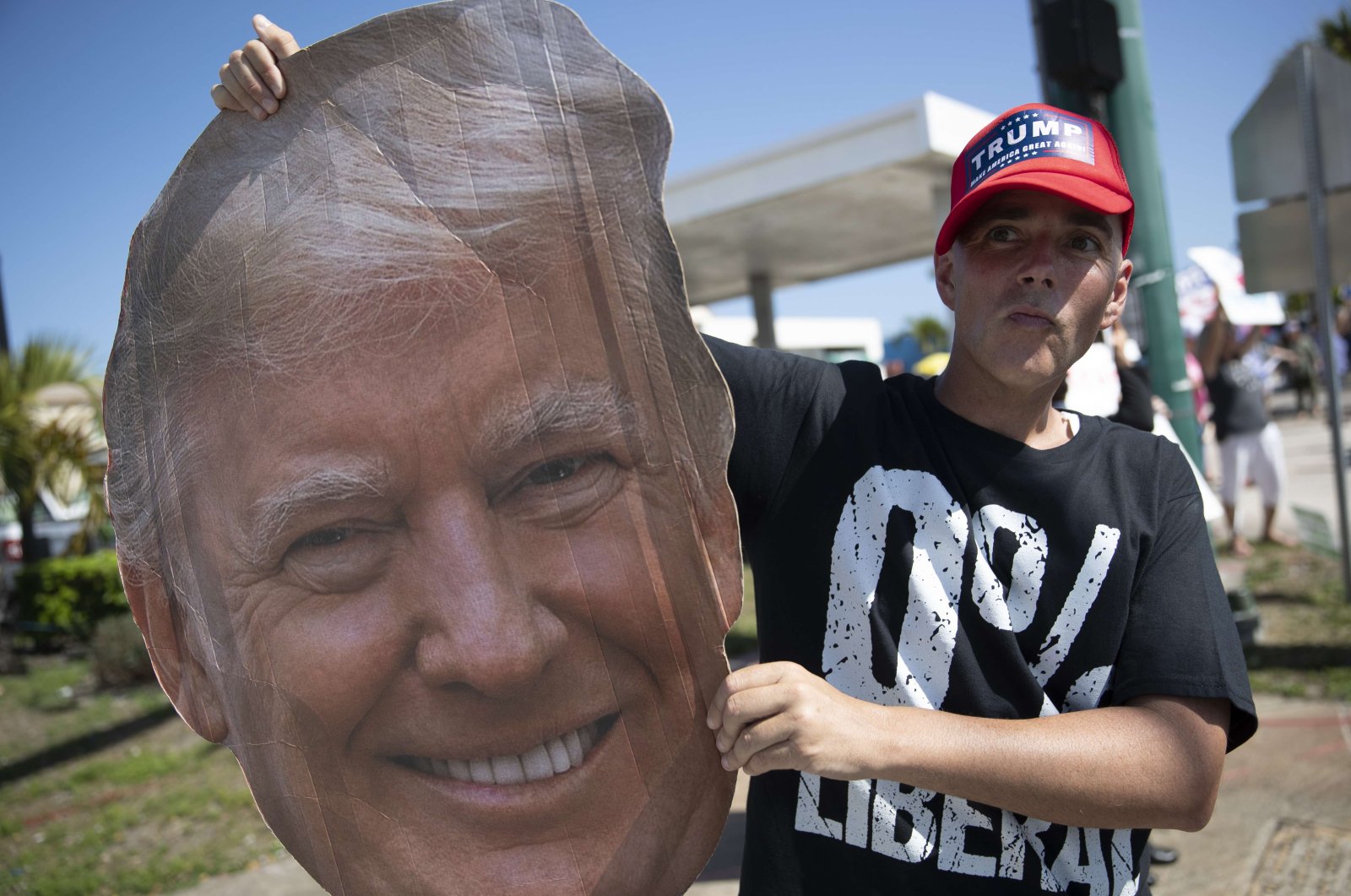 Jonny Riches and other supporters of former U.S. President Donald Trump gather along Southern Blvd near Trump's Mar-a-Lago home in West Palm Beach, Florida, Feb. 15, 2021. (AFP Photo)