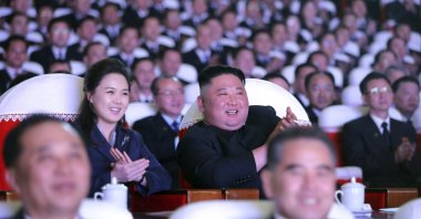 In this photo provided by the North Korean government, North Korean leader Kim Jong Un and his wife Ri Sol Ju watch a performance marking the birth anniversary of Kim Jong Il, Pyongyang, North Korea, Feb. 16, 2021. (AP Photo)