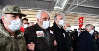 Şevket Altıntaş (C), the father of Müslüm Altıntaş who was executed by PKK terrorists in northern Iraq, attends the funeral ceremony of his son with Justice Minister Abdulhamit Gül (R) in Gaziantep province, southeastern Turkey, Feb. 16, 2021. (AA Photo)