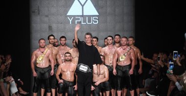 Designer Yakup Biçer (C) poses with Turkish wrestlers on the runway at the Y Plus By Yakup Bicer show during Mercedes-Benz Istanbul Fashion Week at Zorlu Performance Hall on October 9, 2019 in Istanbul, Turkey. (Getty Images for IHKIB)