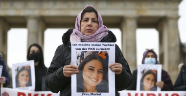 Maide T. holds a photo of her daughter, who was abducted by the PKK in a protest in front of Brandenburg Gate, Berlin, Germany, Nov. 17, 2020. (AA Photo)