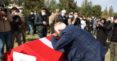 Şeyhmus Kaya, the father of slain police officer Vedat Kaya, bids farewell to the martyr during a funeral ceremony organized in his hometown southeastern Mardin province on Feb. 15, 2021 (AA Photo)