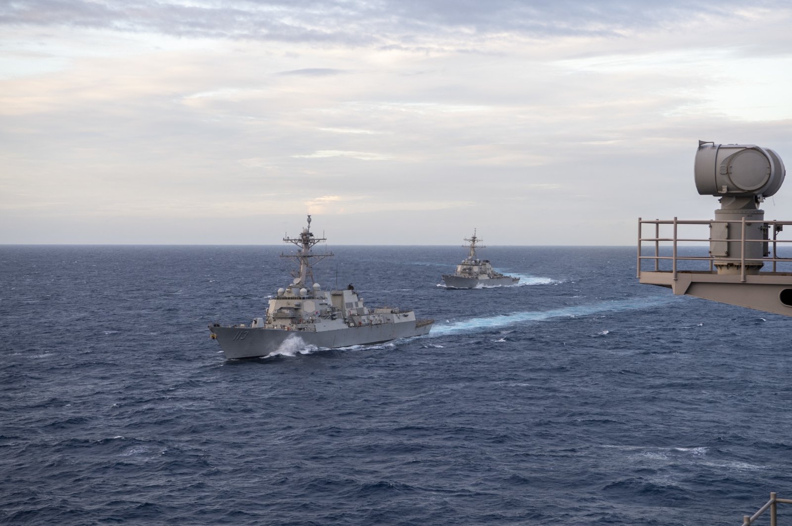 The Arleigh Burke-class guided-missile destroyer USS John Finn (DDG 113) (L) and the Arleigh Burke-class guided-missile destroyer USS Russell (DDG 59) move into formation alongside the aircraft carrier USS Theodore Roosevelt (CVN 71) during dual-carrier operations with the Nimitz Carrier Strike Group in the South China Sea, Feb. 9, 2021. (Reuters Photo)