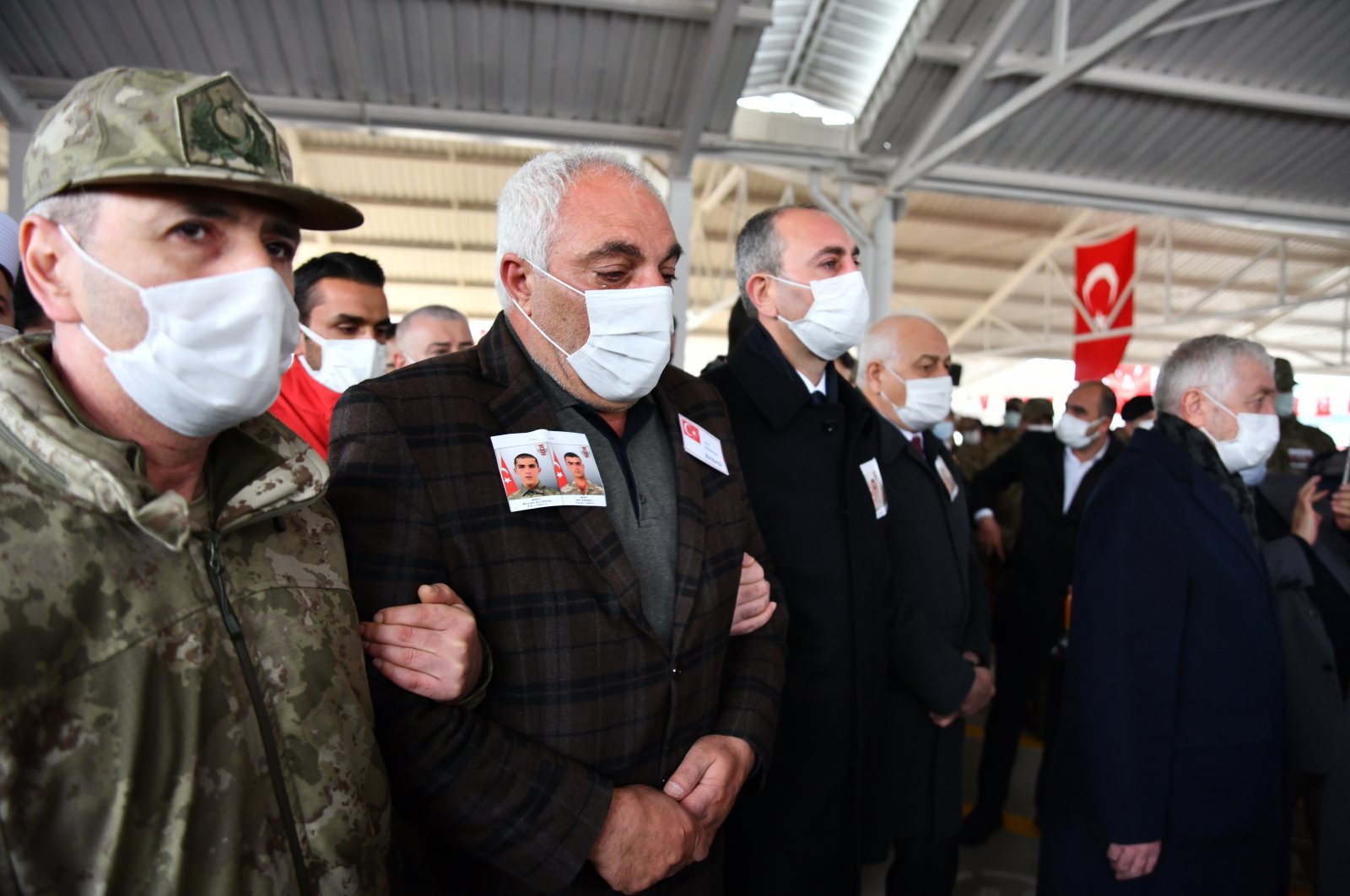 Şevket Altıntaş (C), the father of Müslüm Altıntaş who was executed by PKK terrorists in northern Iraq, attends the funeral ceremony of his son with Justice Minister Abdulhamit Gül (R) in Gaziantep province, southeastern Turkey, Feb. 16, 2021. (AA Photo)