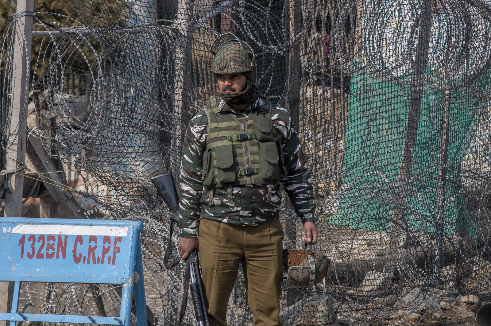 An Indian paramilitary soldier stands guard outside a paramilitary post during a strike to mark the anniversary of Kashmiri leader Maqbool Bhat's death in Srinagar, Indian controlled Kashmir, Feb. 11, 2021. (AP Photo)