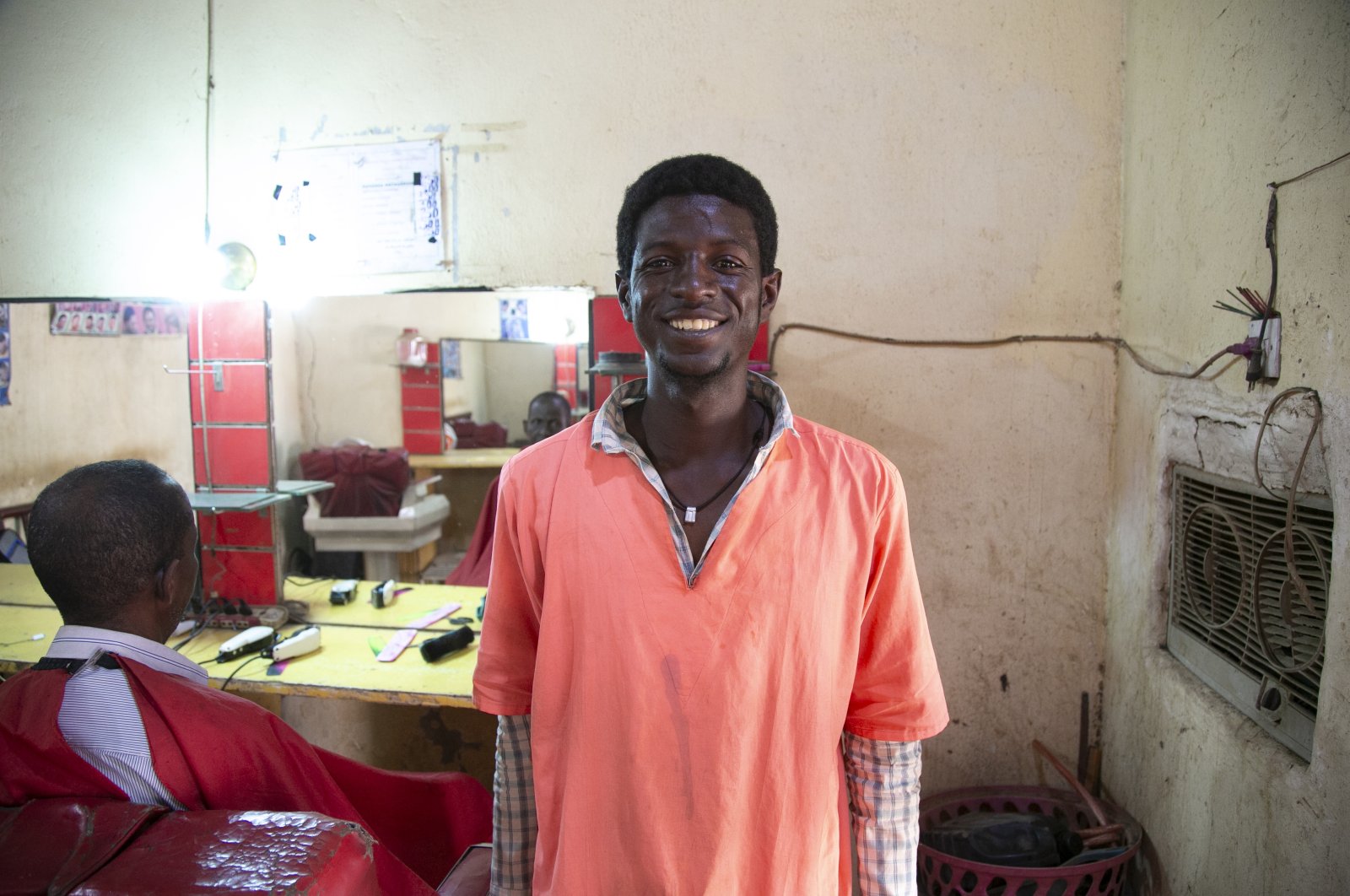 Abdulmohsen Babekir Abdullah Moussa in the barbershop where he works, in Khartoum, Sudan, Feb. 17, 2021. (AA Photo)